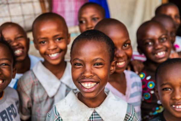 orphans Group of colorful dressed, happy African children, orphanage in Kenya. There is no light and electricity inside the classroom. Around 20-30 orphans live in this orphanage which is located near Nairobi.